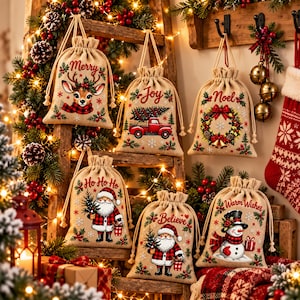 May include: Six beige drawstring hessian gift bags featuring Christmas graphics and text. Designs include a reindeer with Merry, a truck with Joy, a wreath with Noel, Santa with Ho Ho Ho, Santa with Believe, and a snowman with Warm Wishes.