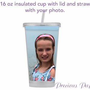 May include: A clear 16 ounce insulated cup with a lid and straw. The cup has a photo of a girl with a pink headband on it.