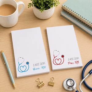 May include: Two white notepads with a stethoscope design in blue and red, with the text "A NOTE FROM Stacie, RN" and "A NOTE FROM Pam, RN". A pen, coffee mug, and stethoscope are also visible.