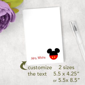 May include: A white rectangular card featuring the red text Mrs. White and a black and red mouse ear icon. The card includes the text customize the text, 2 sizes, 5.5 x 4.25 inches, or 5.5 x 8.5 inches. A clear pen is positioned to the right.