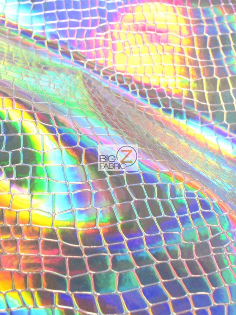 May include: A close-up of iridescent holographic fabric with a snake skin pattern. The fabric has a silver base with a rainbow sheen.