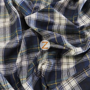 May include: A close-up of a blue, white, and yellow plaid fabric. The fabric is folded and has a soft, textured feel.