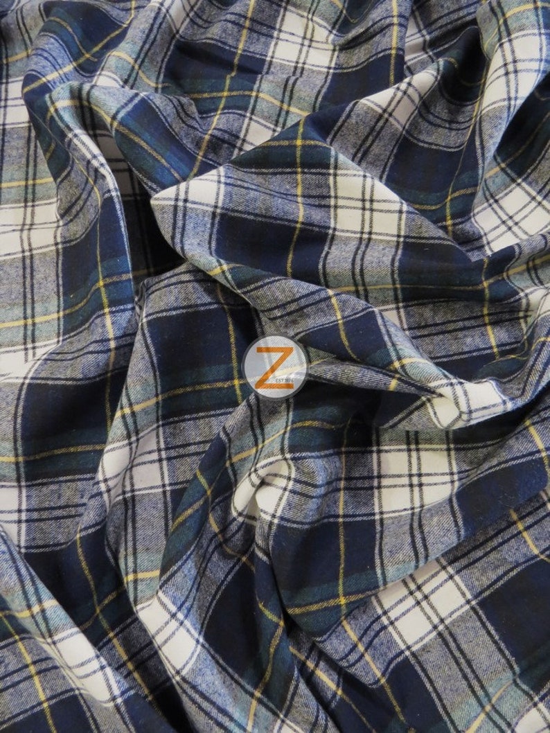 May include: A close-up of a blue, white, and yellow plaid fabric. The fabric is folded and has a soft, textured feel.