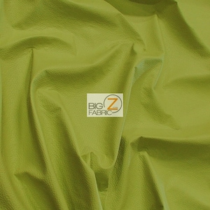 May include: Close-up of a textured, green fabric. The fabric is soft and has a slight sheen. The fabric is folded in a way that shows its texture and drape. The fabric is labeled "BIG Z FABRIC".