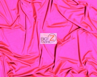 May include: A bright pink, smooth, stretchy fabric with a slight sheen. The fabric is folded and draped, showing its texture and drape. The fabric is labeled "BIG Z FABRIC".