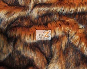 May include: Close-up of a brown and black faux fur fabric with a long pile. The fabric has a striped pattern and is soft and fluffy.