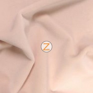May include: A close-up of a blush-coloured fabric with soft folds. The text "24. BLUSH" is in an orange, stylised font in the upper left corner. A circular logo with the letter "Z" is in the centre.