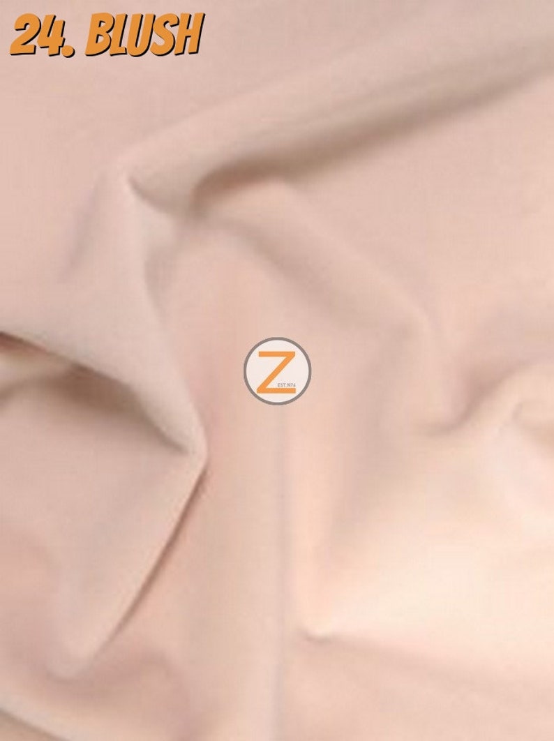 May include: A close-up of a blush-coloured fabric with soft folds. The text "24. BLUSH" is in an orange, stylised font in the upper left corner. A circular logo with the letter "Z" is in the centre.