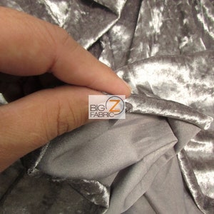 May include: Close-up of a silver crushed velvet fabric with a subtle sheen. The fabric is soft and has a luxurious feel.