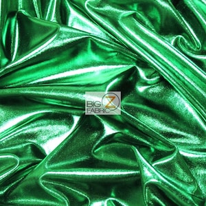 May include: A close-up of a bright green metallic fabric with a shiny, textured surface. The fabric is draped and folded, showcasing its drape and texture.
