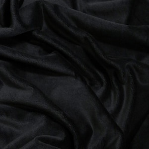 May include: Black fabric with a soft, plush texture. The fabric is folded and draped, creating a smooth, flowing surface.