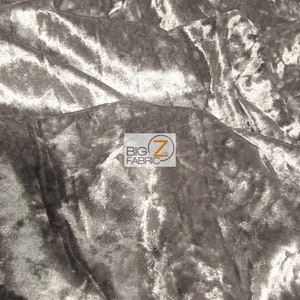May include: Close-up of a silver crushed velvet fabric. The fabric has a soft, luxurious feel and is perfect for upholstery, curtains, and clothing.