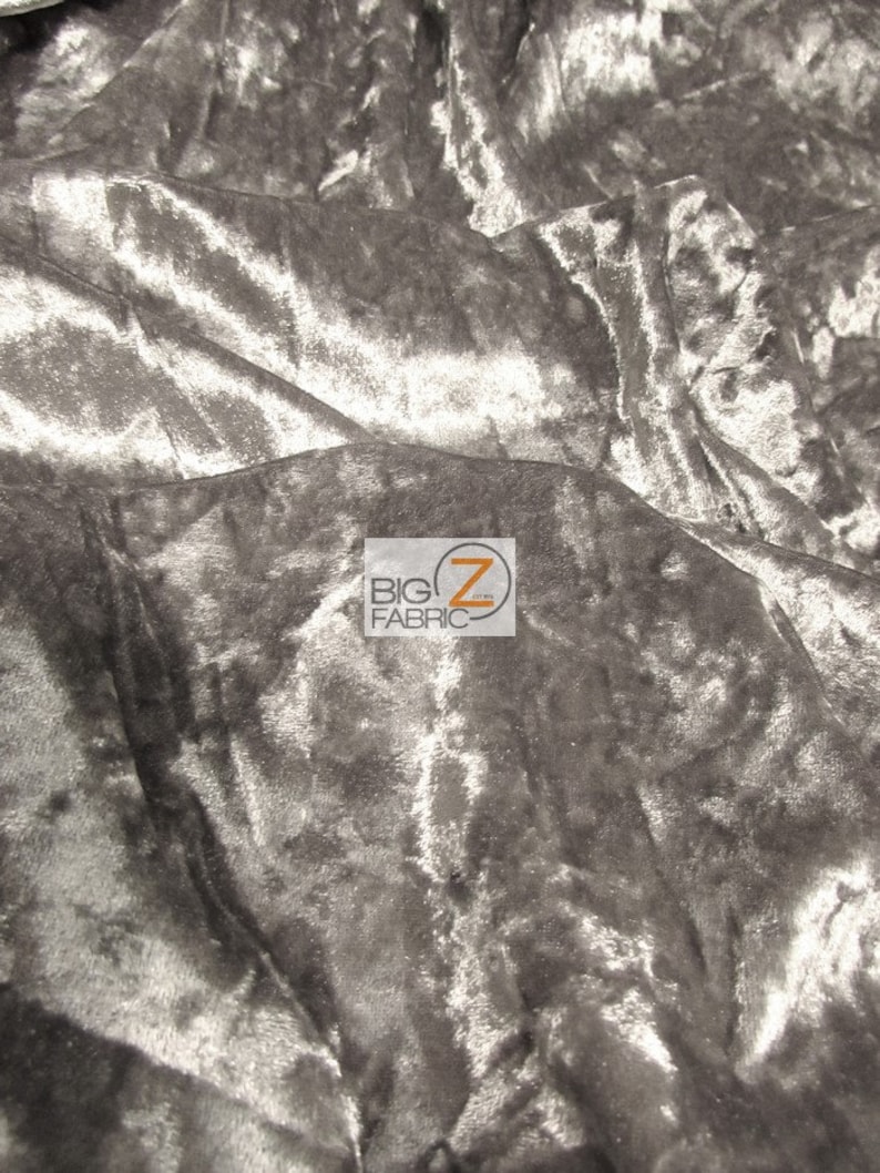 May include: Close-up of a silver crushed velvet fabric. The fabric has a soft, luxurious feel and is perfect for upholstery, curtains, and clothing.