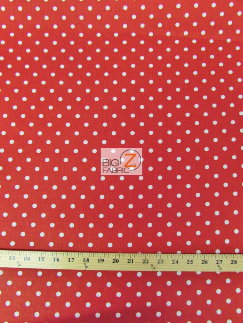 May include: Red fabric with a white polka dot pattern. The fabric is measured with a ruler in inches.