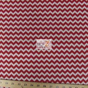 May include: Red and white chevron patterned fabric. The fabric is measured with a ruler in inches.
