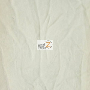 May include: A close-up of a white, textured fabric. The fabric is wrinkled and has a soft, fuzzy appearance.