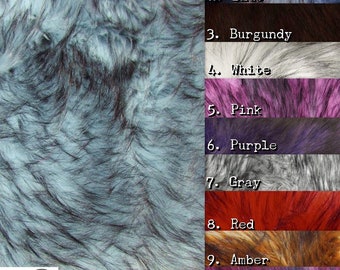 May include: A close-up of a fabric swatch in a light blue color with dark blue and black streaks. The fabric is labeled "Ice Blue" and is part of a larger swatch set with 10 different colors.