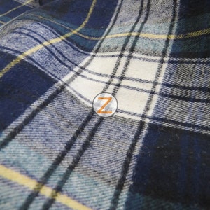 May include: Close-up of a blue, white, and yellow plaid fabric. The fabric has a soft, textured feel and is perfect for crafting projects.
