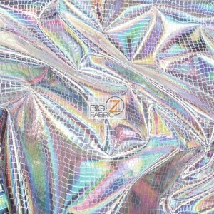 May include: A close-up of iridescent silver fabric with a crocodile skin pattern. The fabric is textured and has a shimmering effect.
