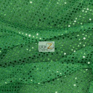 May include: Green sequin fabric with a shiny finish. The sequins are small and evenly spaced.