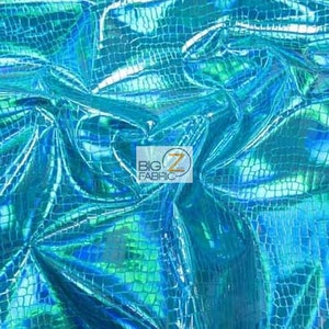 May include: A close-up of iridescent blue fabric with a crocodile skin pattern. The fabric is shiny and has a holographic effect.
