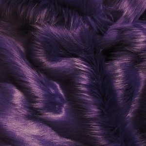 May include: Purple faux fur fabric with a soft, plush texture. The fur is long and fluffy, creating a luxurious look and feel.