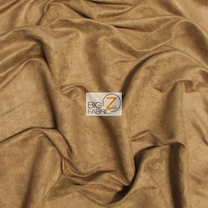 May include: Close-up of a tan-colored fabric with a soft, suede-like texture. The material is draped and folded, creating shadows and highlights. The fabric appears to be a solid color, with no visible patterns or designs. The Big Z Fabric logo is in the bottom right corner.