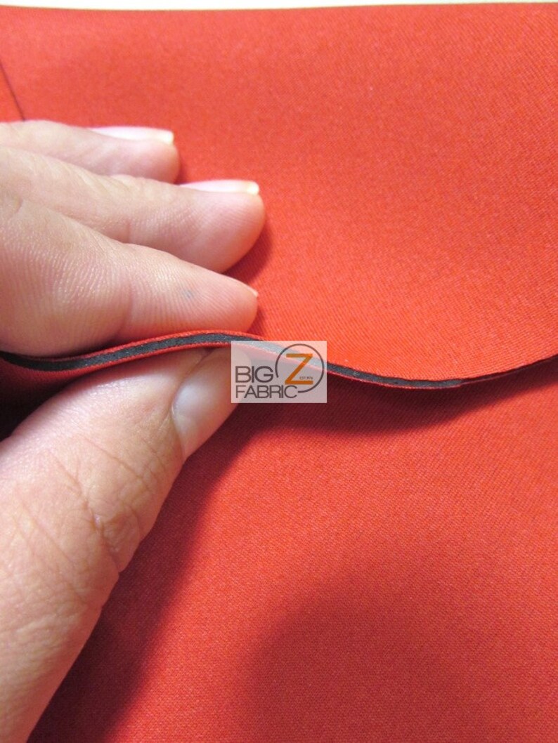 May include: Close-up of a bright red fabric with a black edge. The fabric is smooth and has a slight sheen. The text "BIG Z FABRIC" is visible in the image.