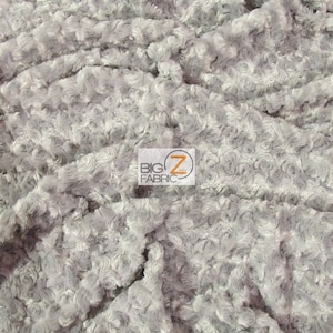 May include: Close-up of a soft, gray, fluffy fabric with a rose-like texture. The fabric is made of polyester and is perfect for crafting projects, blankets, and more.