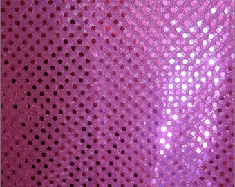 May include: Pink fabric with a glittery polka dot pattern. The dots are a slightly darker shade of pink than the background.