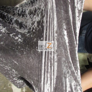 May include: Close-up of a silver crushed velvet fabric. The fabric has a soft, luxurious feel and is perfect for upholstery, curtains, or clothing.