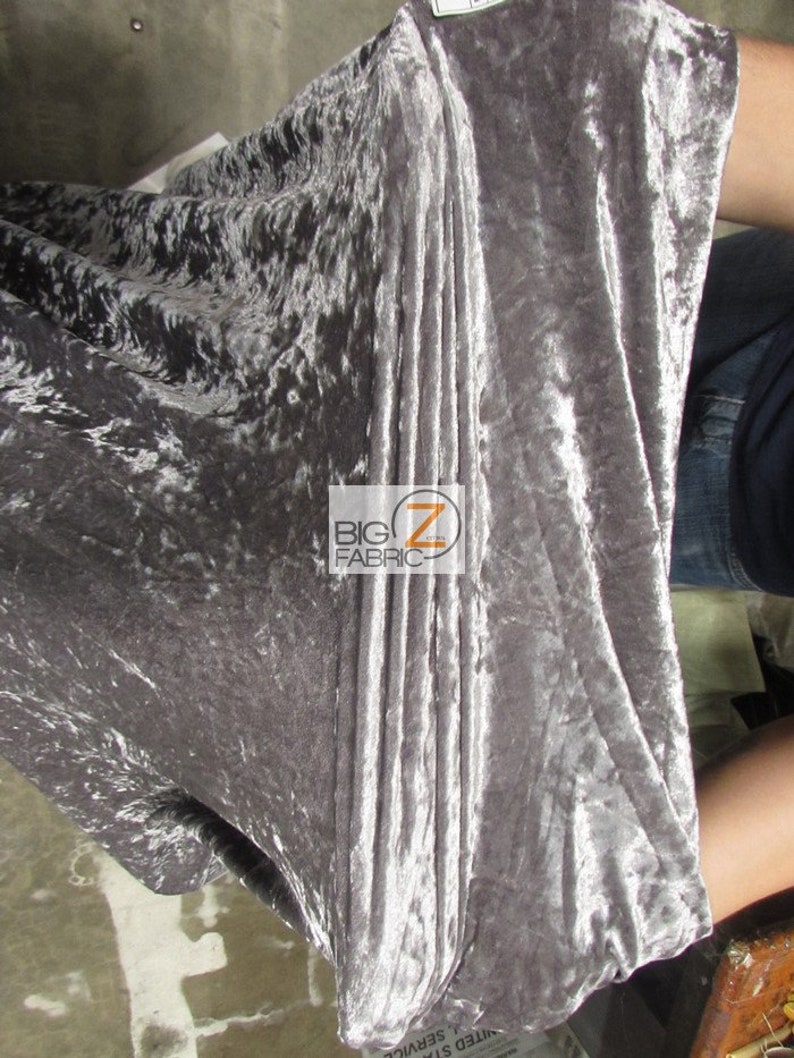 May include: Close-up of a silver crushed velvet fabric. The fabric has a soft, luxurious feel and is perfect for upholstery, curtains, or clothing.
