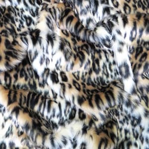 May include: Close-up of a soft, plush fabric with a leopard print pattern in shades of black, white, and brown.