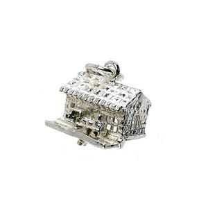 May include: A detailed silver charm in the shape of a house, featuring a textured roof and walls. The charm has an open door and a loop for attaching to a necklace or bracelet. The house charm is a symbol of home and security.