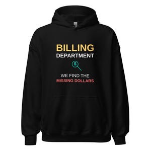 May include: A black hooded sweatshirt featuring the text BILLING DEPARTMENT in yellow and white, a teal magnifying glass icon with a dollar sign, and the text WE FIND THE MISSING DOLLARS in white and light red lettering on the front.