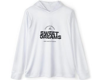May include: A white long-sleeve hooded shirt featuring black text on the chest that reads CUSTOM SLEEPWEAR est. 2021 SWEET DREAMS ... ARE MADE OF FLEECE. The garment has a hood, long sleeves with cuffs, and a straight hemline.