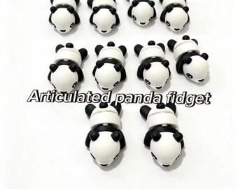 May include: Ten small articulated panda fidget toys arranged in rows. Each panda figure is white with black ears, limbs, and eye patches. The text Articulated panda fidget is centered in the middle of the image over the figures.