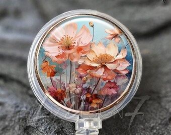 Puede incluir: Portatarjetas transparente con bisel dorado rosa. El carrete presenta un diseño floral con flores melocotón y naranja sobre un fondo azul claro. El texto "Liz Design 7" está en la parte superior.