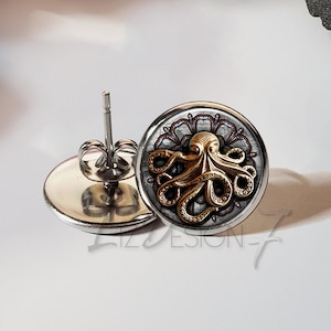 May include: A pair of silver stud earrings with a gold octopus design on a white background.