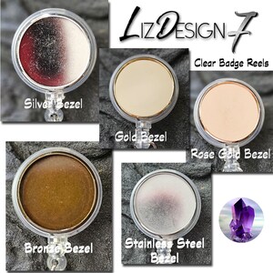 May include: Five clear badge reels with different colored bezels: silver, gold, rose gold, bronze, and stainless steel. The text "Liz Design-7 Clear Badge Reels" is at the top of the image.