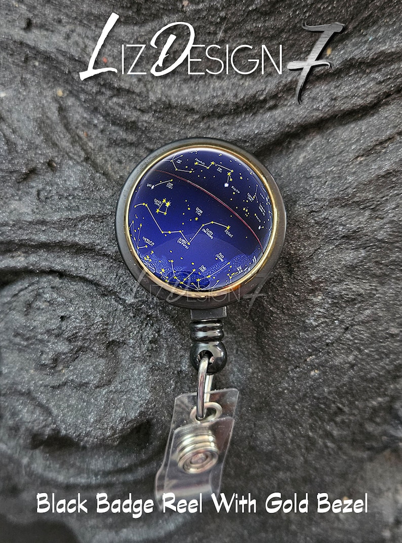 May include: Black badge reel with a gold bezel and a blue and gold design of constellations on the front.