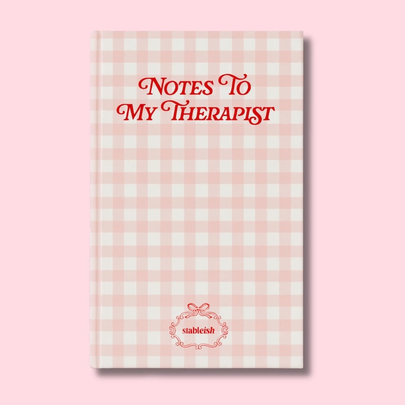 May include: A hardcover notebook with a pink and white gingham pattern. The cover features the text "Notes To My Therapist" in red script. The brand name "stableish" is displayed in a decorative frame at the bottom.