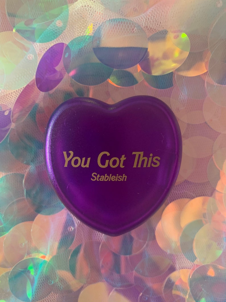May include: Purple heart-shaped stress ball with the text "You Got This" and the word "Stableish" in gold lettering.