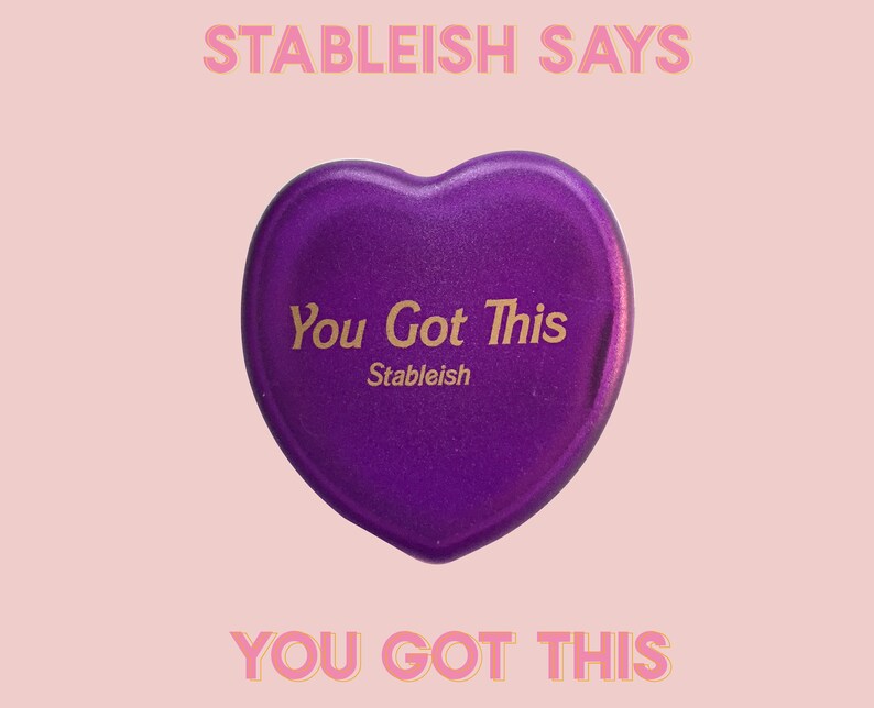 May include: Purple heart-shaped object with the text "You Got This" and "Stableish" in gold lettering.