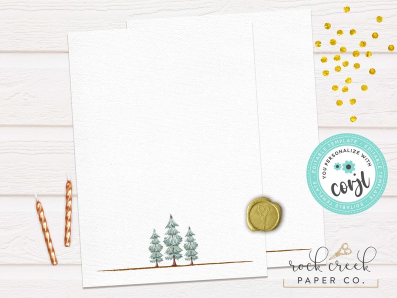 May include: A blank white card with a gold border and a line of small green trees at the bottom. The card is on a white wood background with gold glitter and two gold candles.