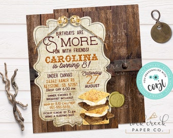 May include: A rustic brown and tan invitation with a s'mores theme. The invitation says "Birthdays are s'more fun with friends! Carolina is turning 8!" and includes details for a party at Under Canvas, 24342 Ranch Rd, Keystone, SD 57751 on Saturday, August 27th. The invitation is editable with Corjl.