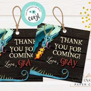 May include: Two blue and green dragon favour tags with a woodgrain background. The text on the tags reads "Thank you for coming! Love, Gray".