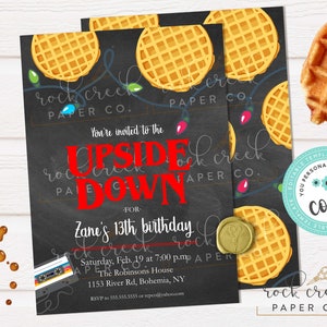 May include: Black invitation card with the text "You're invited to the Upside Down" in red, for Zane's 13th birthday. The design includes waffles, string lights, and a cassette tape.