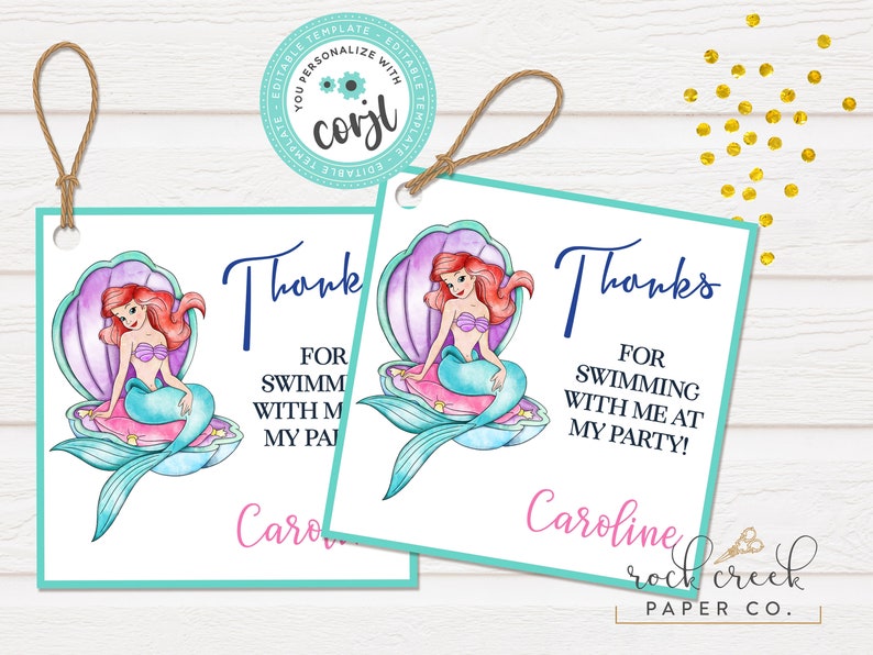May include: Two mermaid-themed thank you tags with a watercolor illustration of Ariel from The Little Mermaid sitting on a seashell. The text on the tags reads "Thanks for swimming with me at my party!" and is personalized with the name "Caroline". The tags are teal and white with a pink and purple seashell.