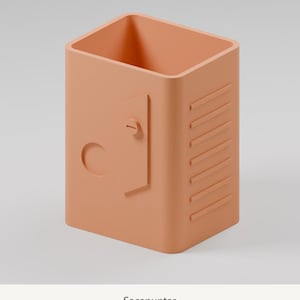 May include: A peach-colored pencil sharpener with a rectangular shape, featuring a small door-like detail with a circular knob and a series of horizontal raised lines on the side. The word Sacapuntas is printed below the object.